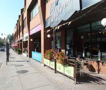 This area is characterized with a Main Street feel, two lanes of traffic, on-street parking, outdoor cafes, street furniture, public art, standardized lighting and iconic heritage properties.