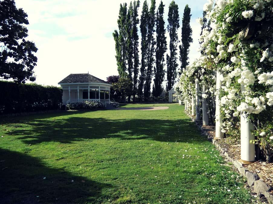 BELVEDERE + LAWNS A charming rosa stone walkway and grassy aisles leading to a center lawn area with a Queen Anne