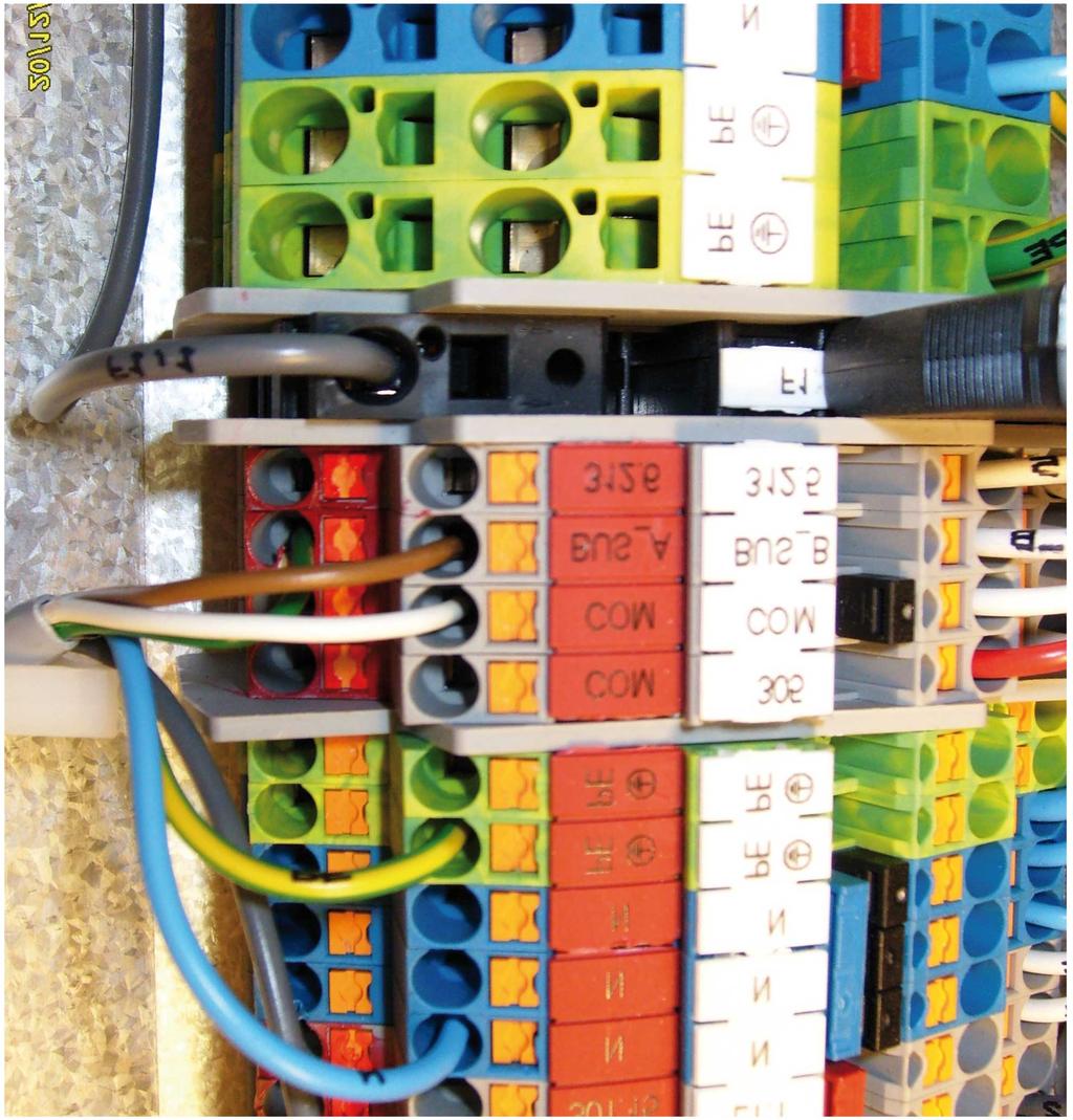 Connect the communication cable to the terminal block (control unit) as follows: Connect a wire to the X2 terminal block connection marked BUS_A. See position 1.