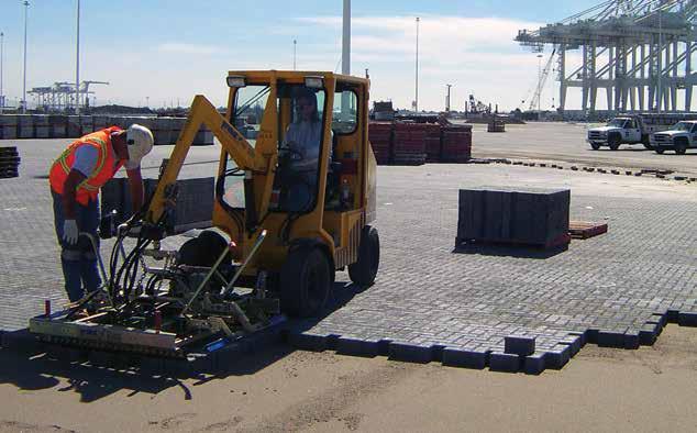 Figure 8. Mechanical installation equipment places concrete pavers rapidly. environmental impacts. This provides lower down times and user costs especially on high use urban roads and sidewalks.