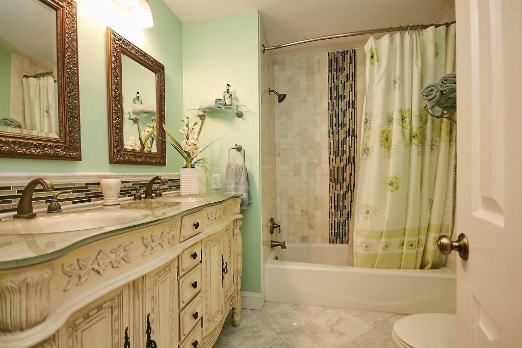 makeup station, a turbo massage jetted tub, walk-in shower with marble tiles,