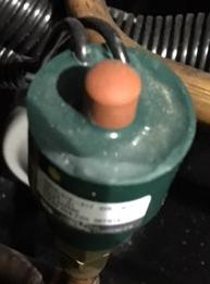 Remove cap on Hot Gas Bypass Valve and using an allen wrench turn valve counter clockwise to decrease the suction pressure and clockwise to increase the suction pressure.