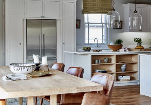 Open shelving cabinets throughout this design allows for displaying favourite items, meaning personality can shine in this classic kitchen in the heart of the countryside.