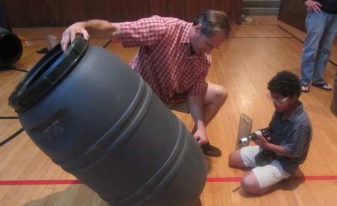 Workshop participants work with trained experts to convert 55 gallon plastic food-grade drums into rain barrels.