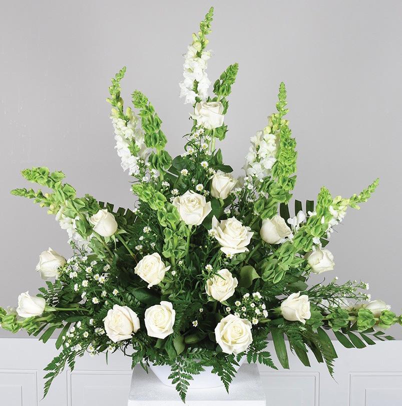 Ireland 8 stems white aster 5 stems white snapdragons 10 stems leather leaf Oval boat pot