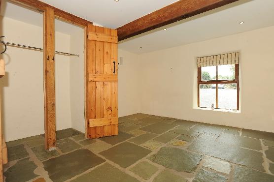 REAR HALL Stone flagged floor; feature electric oil lamps; beam vacuum points. BEDROOM 1 3.89m (12'9) x 3.