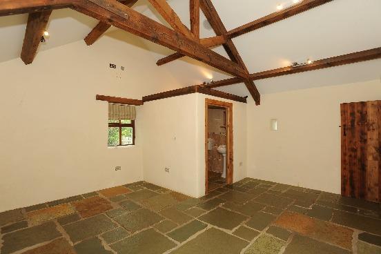 86m (12'8) x 3.68m (12'1) Stone flagged floor; timber beamed ceiling with 12 volt lighting; high level tv aerial jack point and power point.