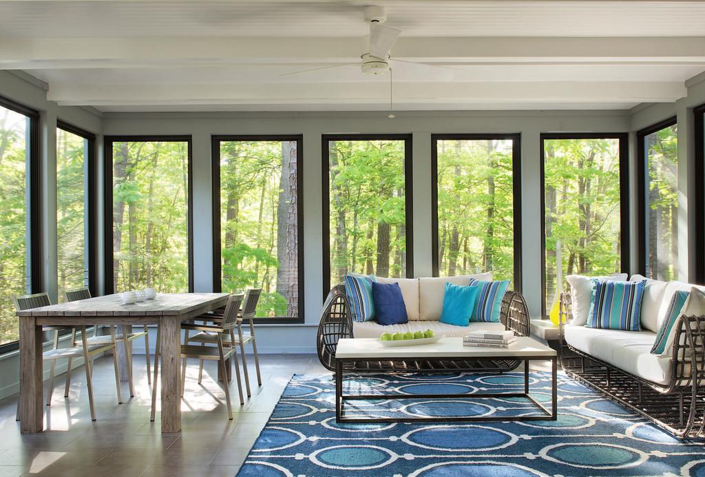 A screened porch off the main floor provides passive ventilation and converts to a winter solarium with glass-panel inserts.