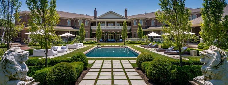 STUNNING EXTERIOR Gracious wraparound terraces overlook the pool and private golf course.