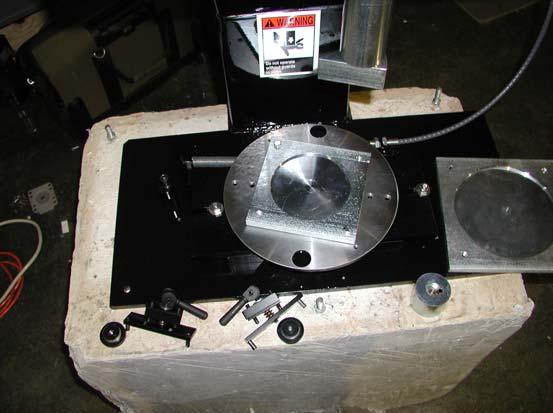There are two nuts located under the mold platen which adjust the toggle clamps for a secure,snug fit to the mold base.