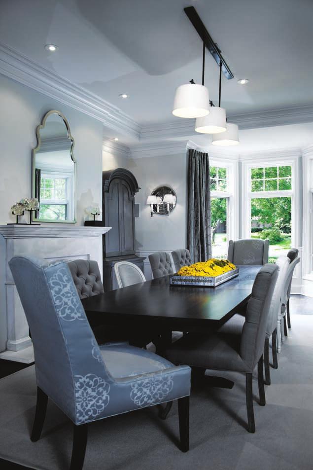 An expandable trestle table, wool sisal rug, and gray-gesso painted armoires round out the beauty.