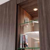 flush with door fronts. Open shelf robe unit with glass shelves and downlights make a stunning feature.