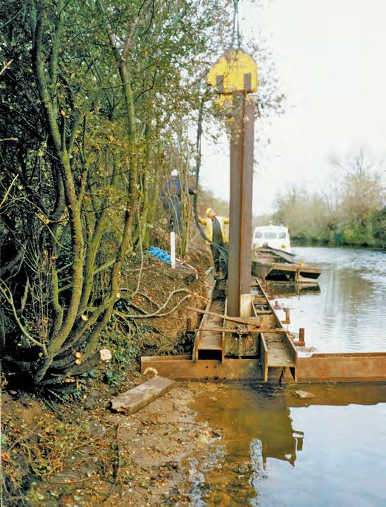 Initial sheet piling after bagwork removal, over existing trees allow continued maintenance dredging) with an above-water soft approach promoting vegetation growth.