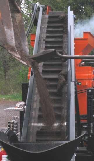 Loading of the preheat hopper is accomplished by a hydraulic driven loading conveyor that is positioned below on the hitch for ground loading or can be loaded from a towing vehicle with the