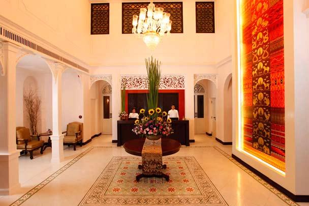 above the doors and windows. The hotel has a majestic and magnificent lobby with a high ceiling and traditional colonial chandelier at the center of the room.