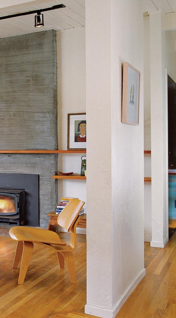 A cement plaster wall makes a statement Another notable design element The Wall, as they call it appears on the east side of the house, running the entire length of the addition.