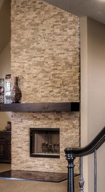 With tall ceilings and an open floor plan, the fireplace s presence was almost invisible. Stone was added to the front and sides all the way to the ceiling.