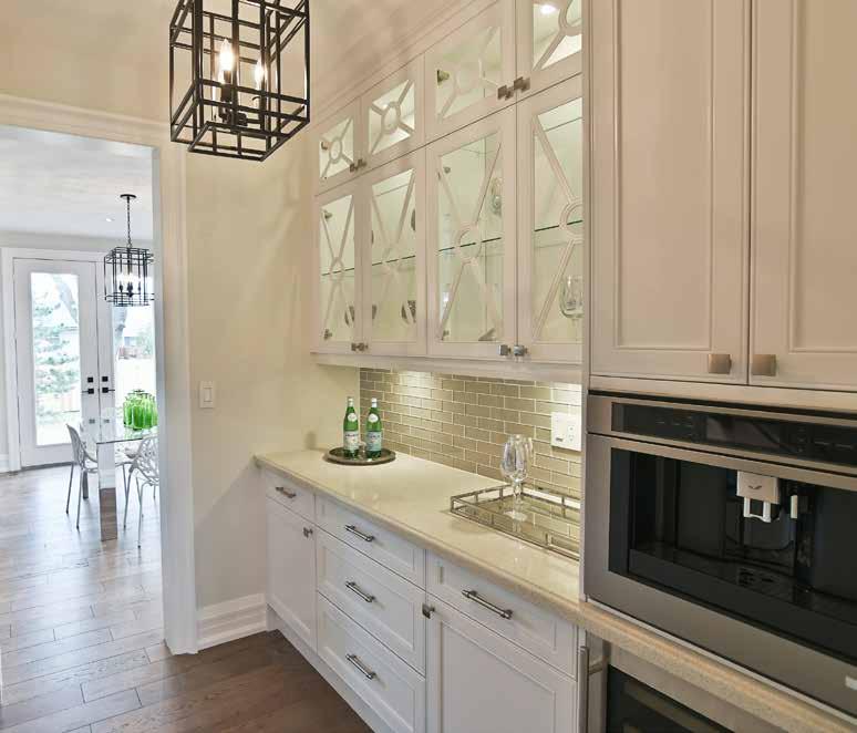 The custom, gourmet kitchen showcases a huge centre island with breakfast seating.
