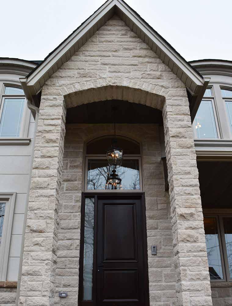 EXTERIORS A visually appealing exterior of Indiana limestone and stucco is complimented with soffit pot lighting and exterior light fixtures.