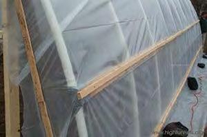Greenhouse Construction: Attaching plastic to frame 1. Place temporary weights on plastic to hold in place 2.