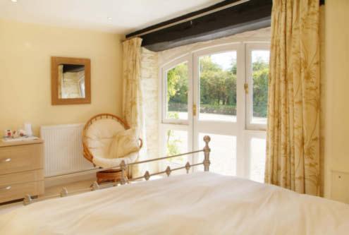THE COACH HOUSE A flight of steps from the gravelled forecourt leads up to a paved terrace with double glazed sliding patio doors opening to:- SITTING ROOM/DINING ROOM A bright and well lit room with