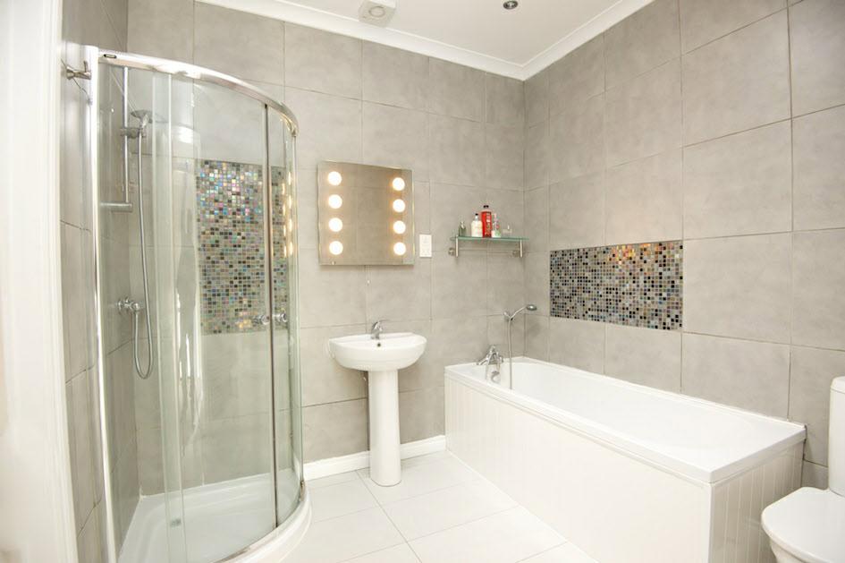 shower, separate corner shower cubicle, low flush wc, pedestal wash hand basin.