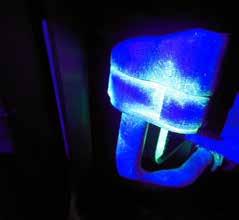 When the A/C components are illuminated with a UV lamp and viewed through yellow UV protection goggles, the leak appears brightly lit up.