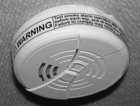 The smoke alarm is powered by a 9-volt battery and has a sensor that is designed to detect smoke.