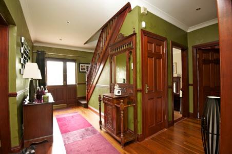 The Property Comprises: COVERED ENTRANCE PORCH: Front door with leaded glass insets and side