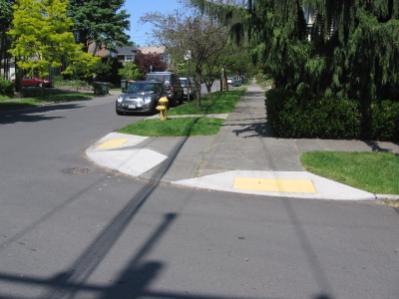 Curb ramps at every intersection provide safe and comfortable access for people with disabilities.
