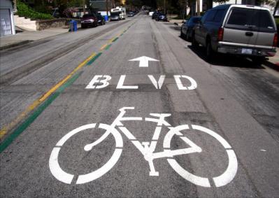 Bicycle Boulevard symbol. Designated bicycle routes may receive special design treatments such as signage, painted roadway symbols, and traffic calming devices.