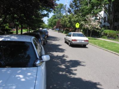 Avoid skinny streets on primary emergency vehicle routes. Prohibit parking within 50 feet of an intersection (to allow fire trucks to make the turn).