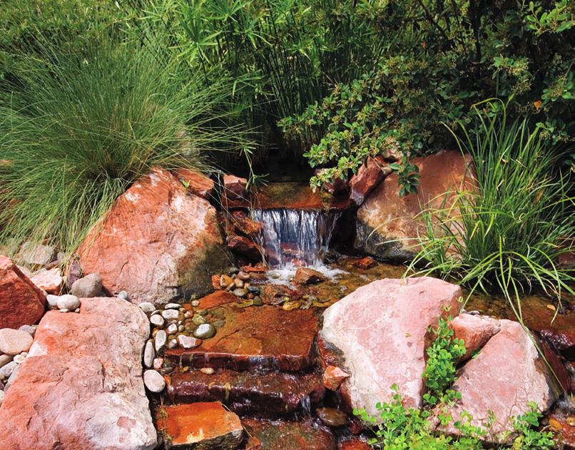 r i g h t: A small waterfall helps provide a soothing ambience and serves as a buffer for traffic noise.