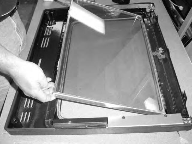 Section 8 - Troubleshooting and Repair Push the glass window assembly out of the door liner from the bottom and lift it out. Replace the window glass assembly.