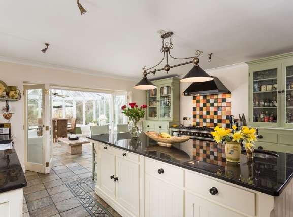 Step through onto the slate tile flooring and feel the warmth from the underfloor heating as you are greeted with a large farmhouse style kitchen with French range cooker.