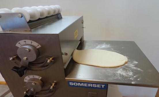 First load the dough in to the top chute, it will come through the first pair of rollers oblong in shape, and from the second set of
