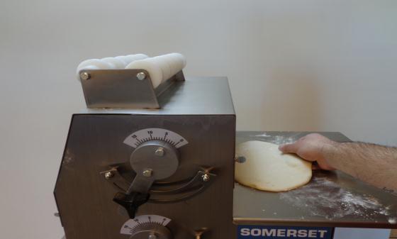 Load the dough into the chute. ** If dough does not slide easily on the discharge trays, dust the trays with flour.