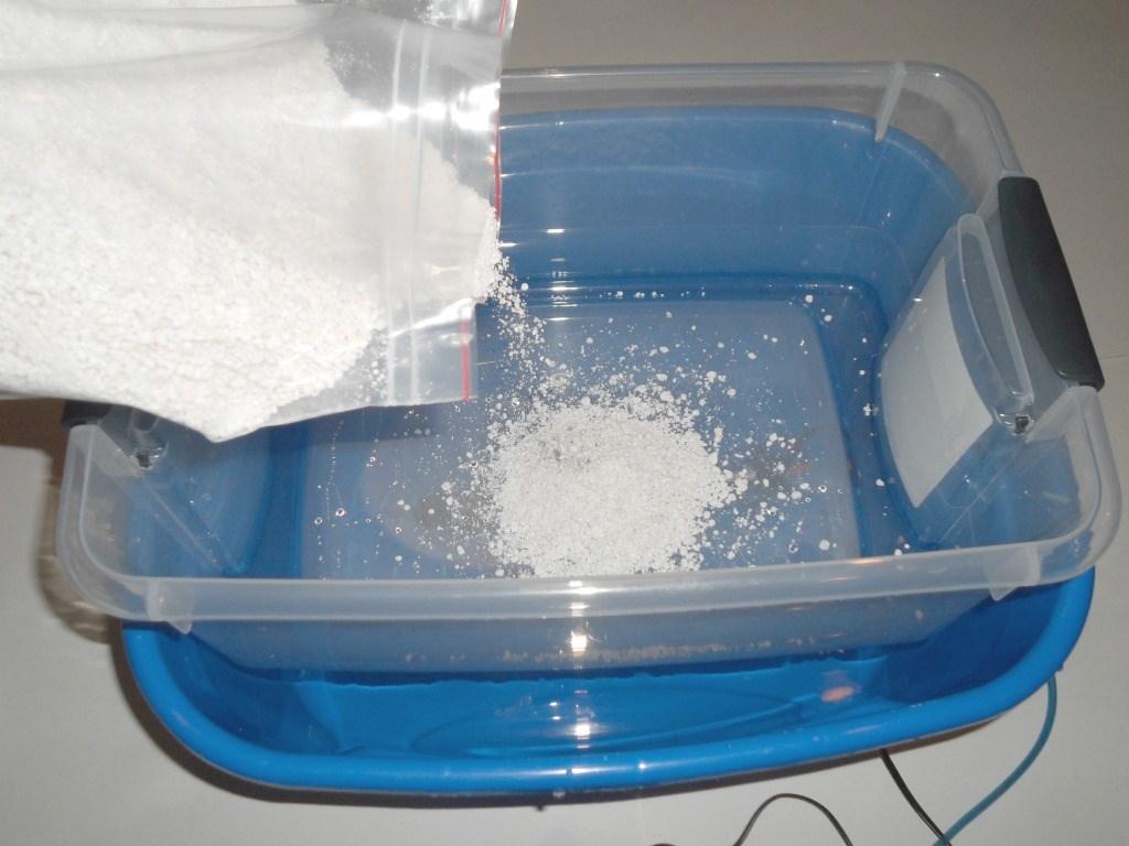 The next step is to add the perlite. The perlite goes on the bottom of the inner chamber after you birth the jars. Mix with filtered water to get a moist mix.