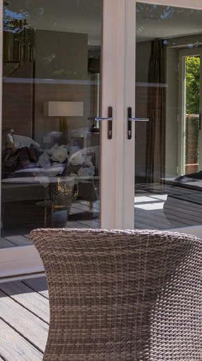 away as bi-fold doors swing open to reveal an impressive Indian sandstone patio and expansive 75m south-facing lawns