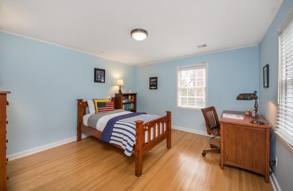 The Master Suite includes a spacious Bedroom with tray ceiling, rich hardwood