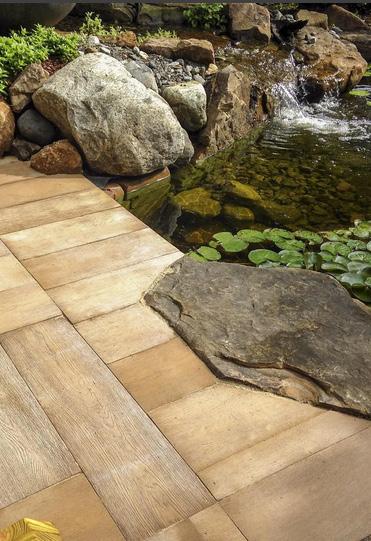 The waterfall starts from a beautiful spillway bowl flowing down next to the paver stairs bringing you to a circular patio bordering the natural area.