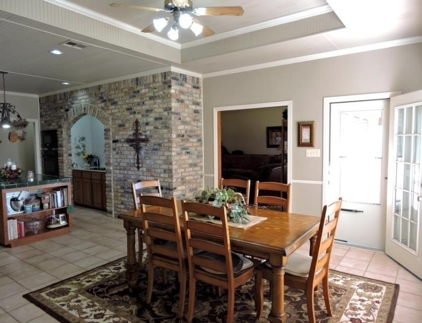 The spacious living area has vaulted ceilings with wood beams and a cozy fireplace.