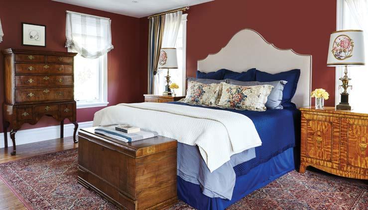 The look in this room is masculine with warm cranberry walls with additional reds, creams, taupes and blues.