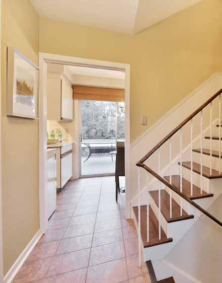 main Level Foyer Upgraded entry door system with extended leaded glass insert opens to the bright foyer Stone look floor tiles Smooth finished ceiling Living Room (5.13 x 3.