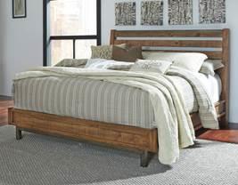 (Signature Design - Millennium) Urban industrial design made of primarily solid wood Warm brown finish with varied natural distressing marks Low platform look bed is anchored by