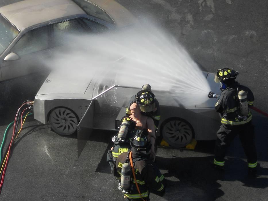 Figure 3. In another scenario, a team of fire fighters has rescued the victim from the hydrogen FCV while continuing to suppress fire in and around the vehicles. 4.