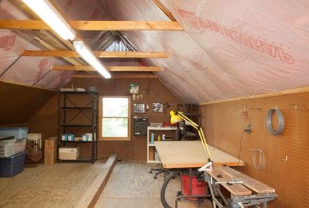Two car garage: Has ample storage cabinets with a two bowl utility sink. A bump out room houses tools and workbench.