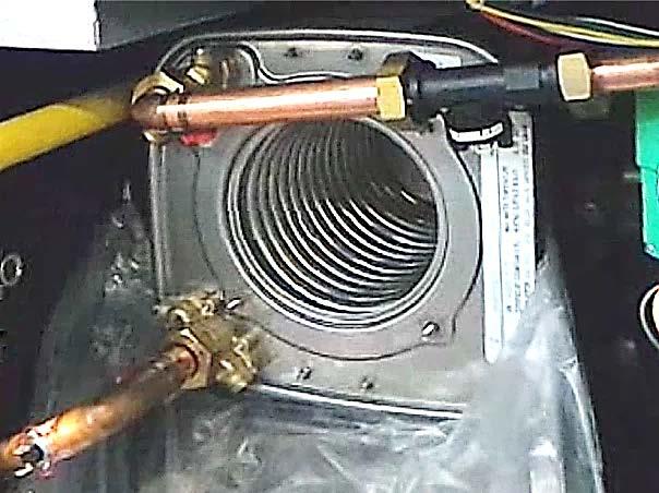 Removing the Heat Exchanger - Continued 10. Completely loosen the water supply nut, as shown in Figure 3-6, using the 46mm wrench. 11.