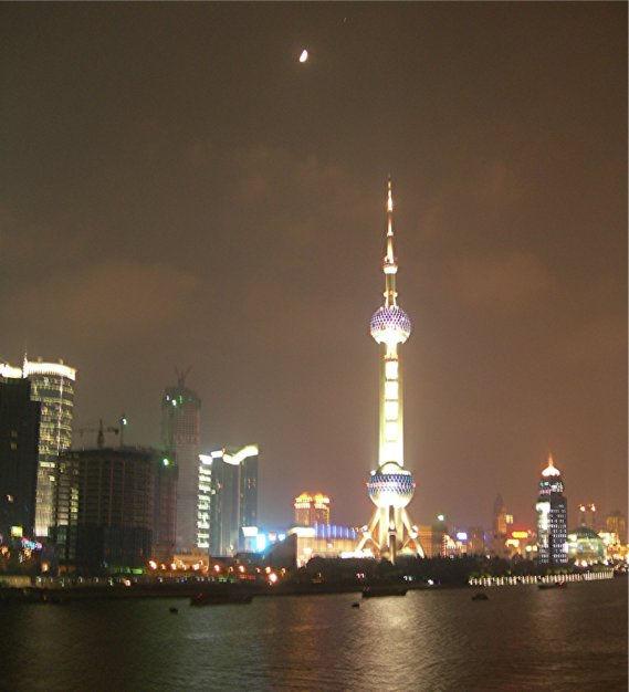 On the right: The Pearl TV Tower with a half moon overhead.