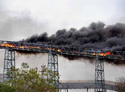 If they should combust upon an unprotected belt, the likelihood is that the system will enable fire to spread into the holding hoppers, blending, crushing or other processing areas of the plant.